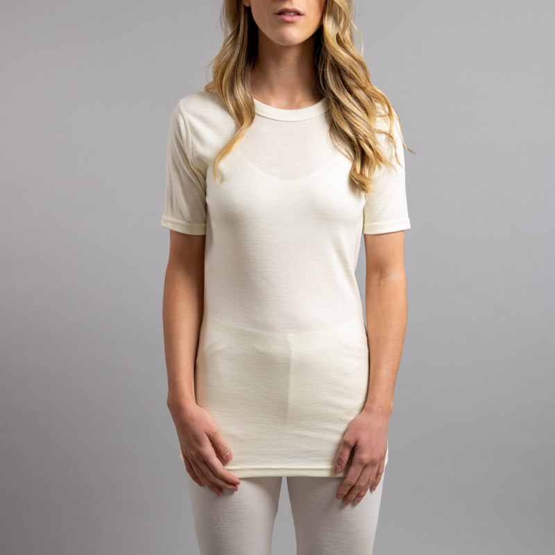 Front view of a female wearing white Merino Skins – Unisex Short Sleeve Crew Neck