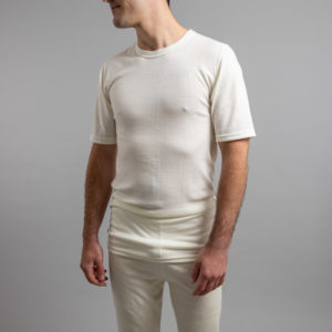 Front view of a male wearing white Merino Skins – Unisex Short Sleeve Crew Neck