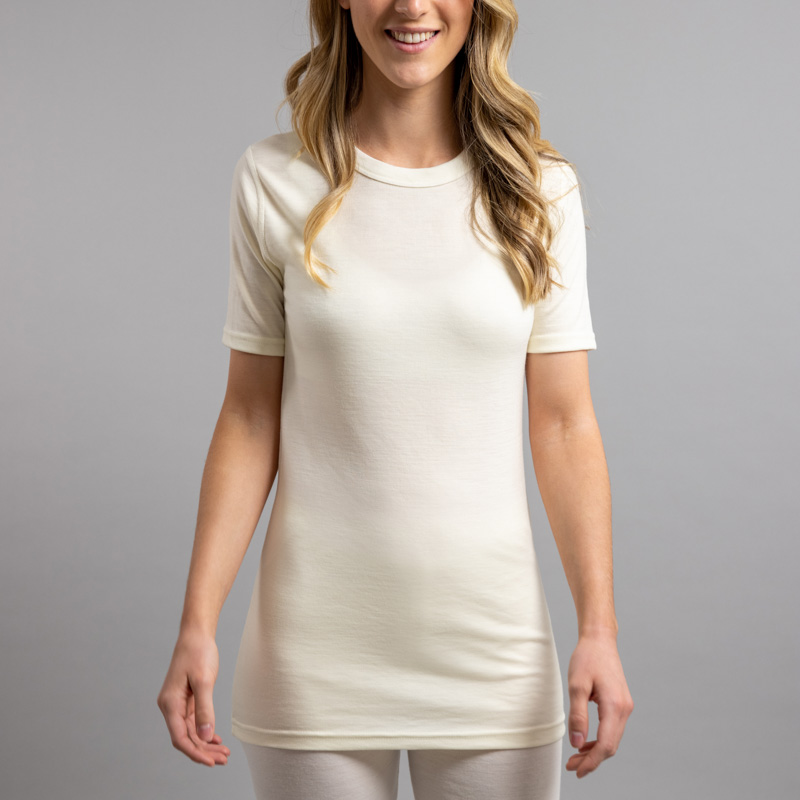 Front view of a female wearing white Merino Skins – Unisex Short Sleeve Crew Neck