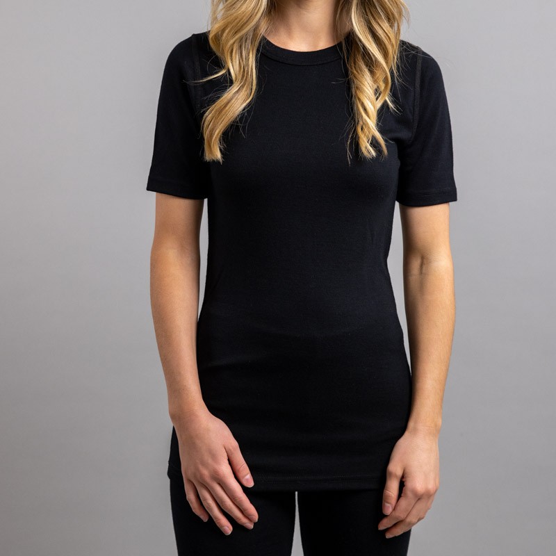 Front view of a female wearing black Merino Skins – Unisex Short Sleeve Crew Neck