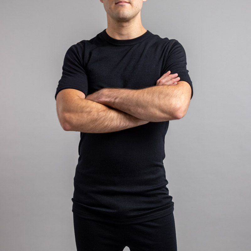 Front view of a male wearing black Merino Skins – Unisex Short Sleeve Crew Neck