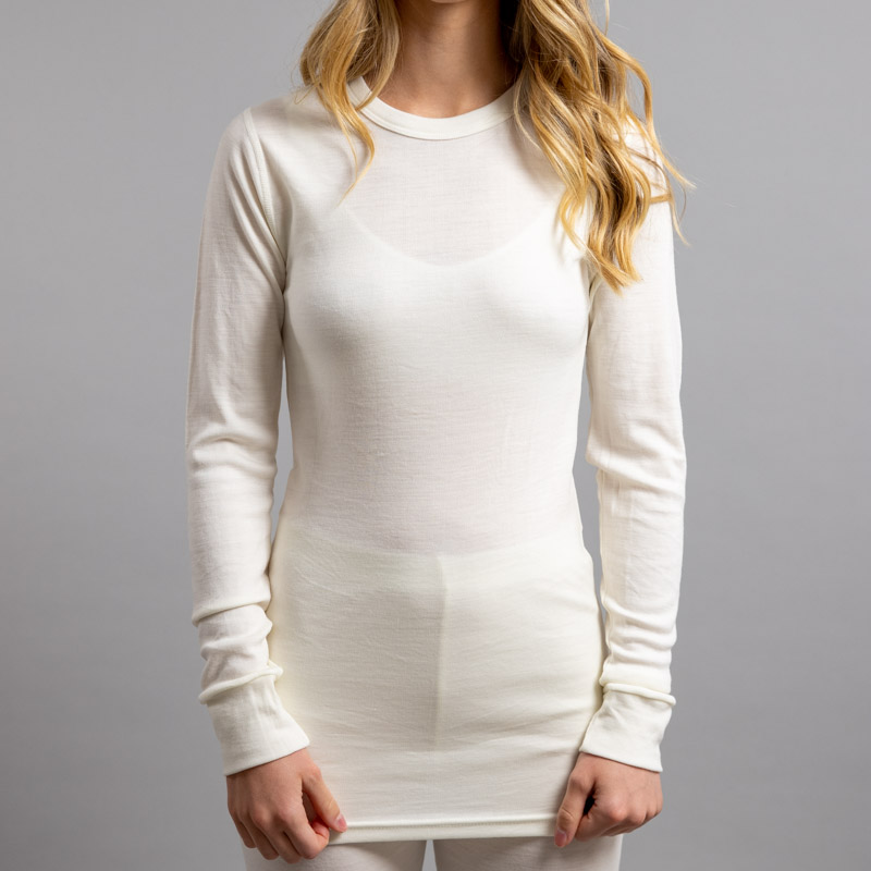 Front view of a female wearing white Merino Skins – Unisex Long Sleeve Crew Neck