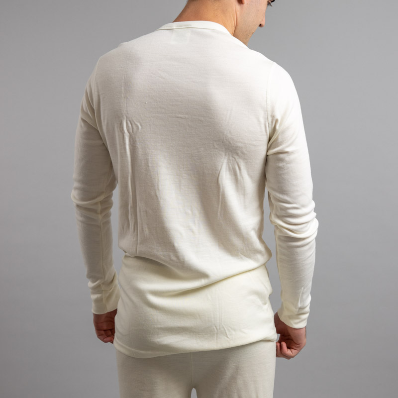 Rearview of a male wearing white Merino Skins – Unisex Long Sleeve Crew Neck