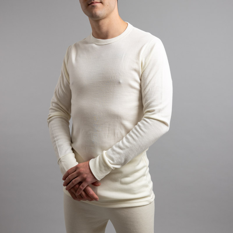 Front side view of a male wearing white Merino Skins – Unisex Long Sleeve Crew Neck