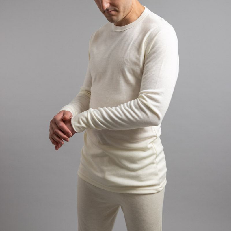 Front side view of a male wearing white Merino Skins – Unisex Long Sleeve Crew Neck
