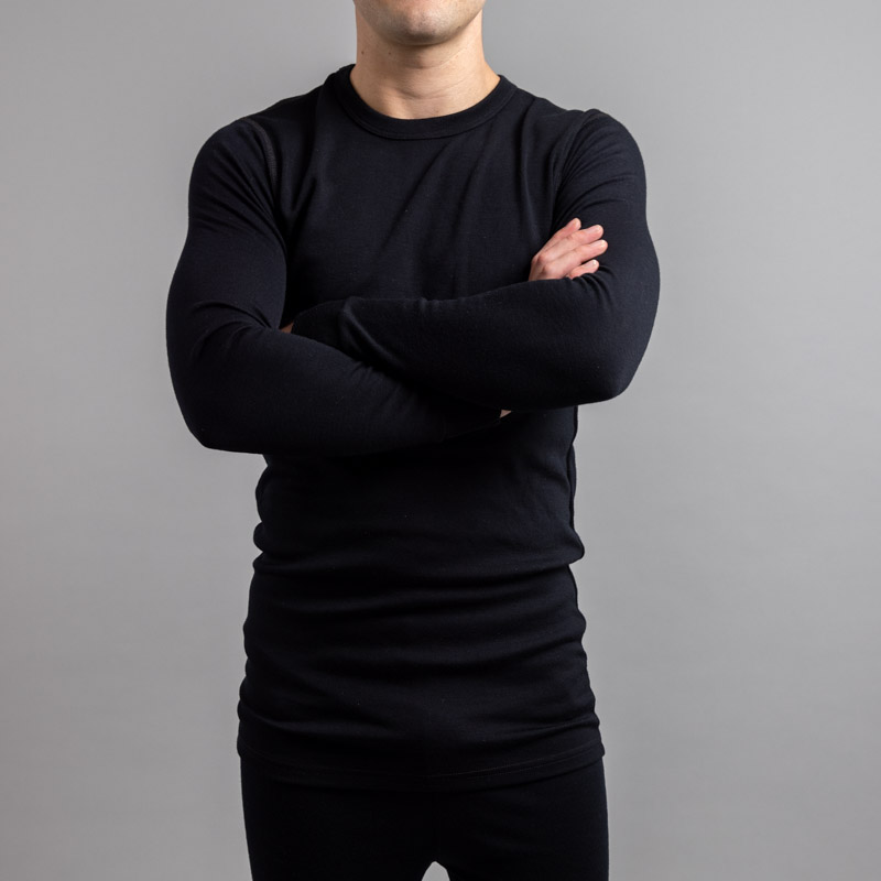 Front view of a male wearing black Merino Skins – Unisex Long Sleeve Crew Neck