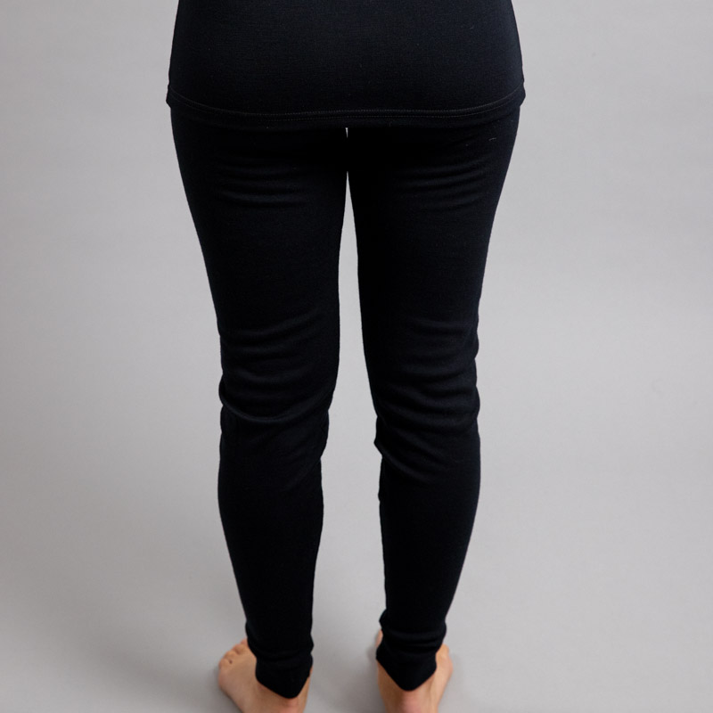 Rearview of a female wearing black Merino Skins - Unisex Long John / Pant