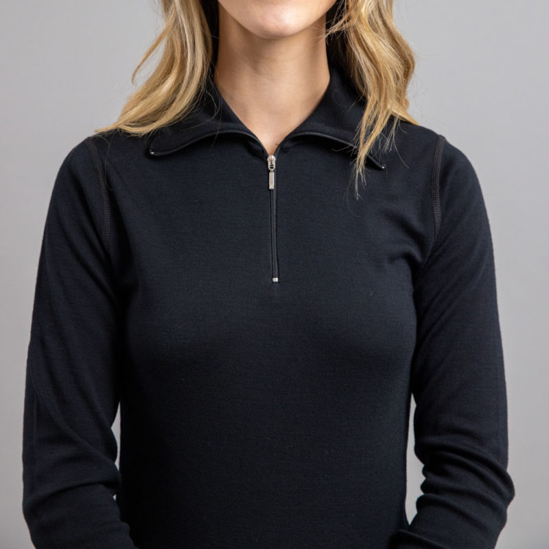 Front view of a lady wearing black Merino Skins – Unisex Long Sleeve Half Zip Front