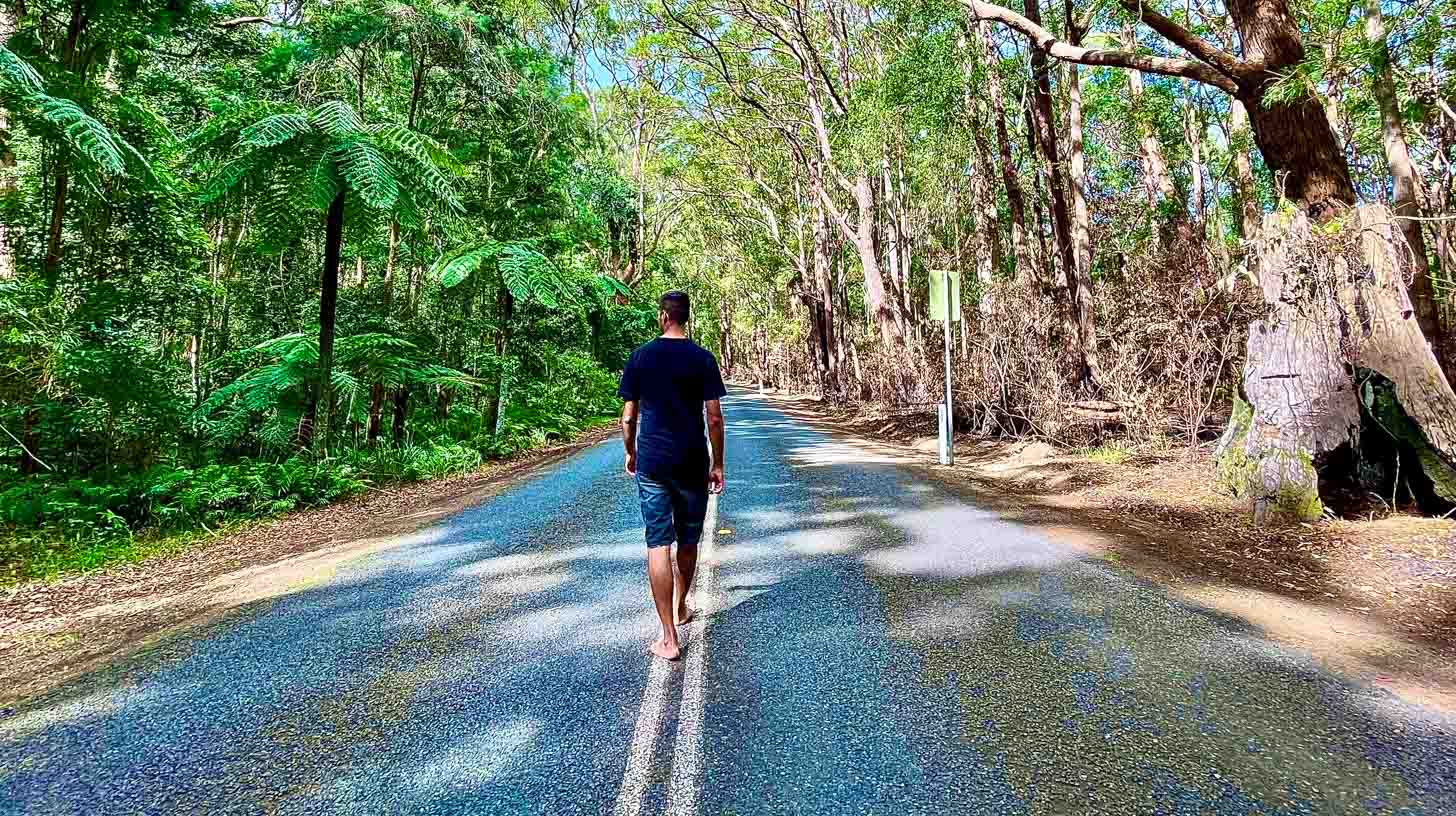 Man walking on bush road wearing Merino Skins t shirt