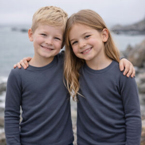 a boy and girl wearing grey Ktena MS Lite merino long sleeve tops